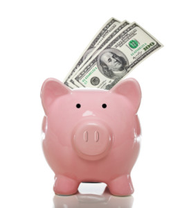Pink piggy bank with 3 one hundred US dollar bills on a white background
